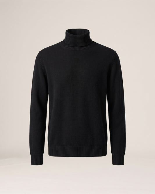 Pull col roulé noir en maille cachemire et laine, vue de face sur fond pierre