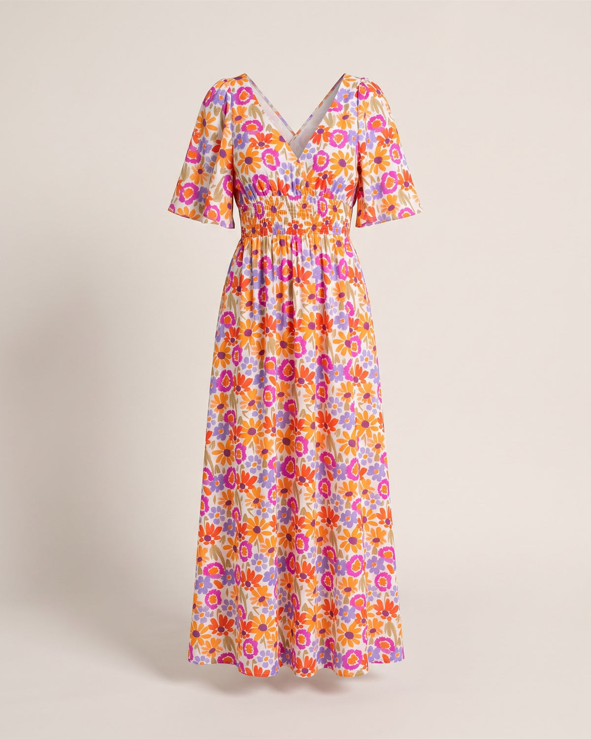 Robe longue dos nu croisé à imprimé floral, vue de face sur fond pierre