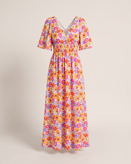 Robe longue dos nu croisé à imprimé floral, vue de face sur fond pierre
