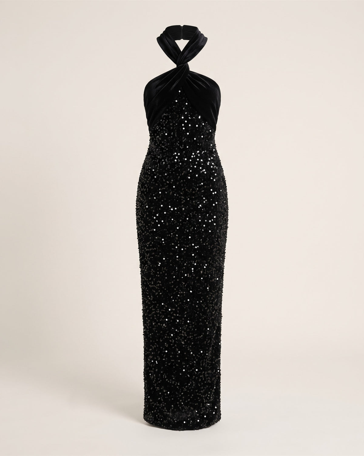 Robe longue noire en sequins et velours à épaule asymétrique, vue de face sur fond pierre